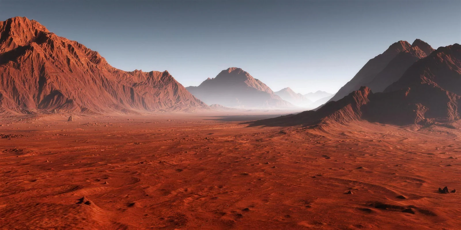The rust-red Martian desert with mountain ranges fading into dusty haze